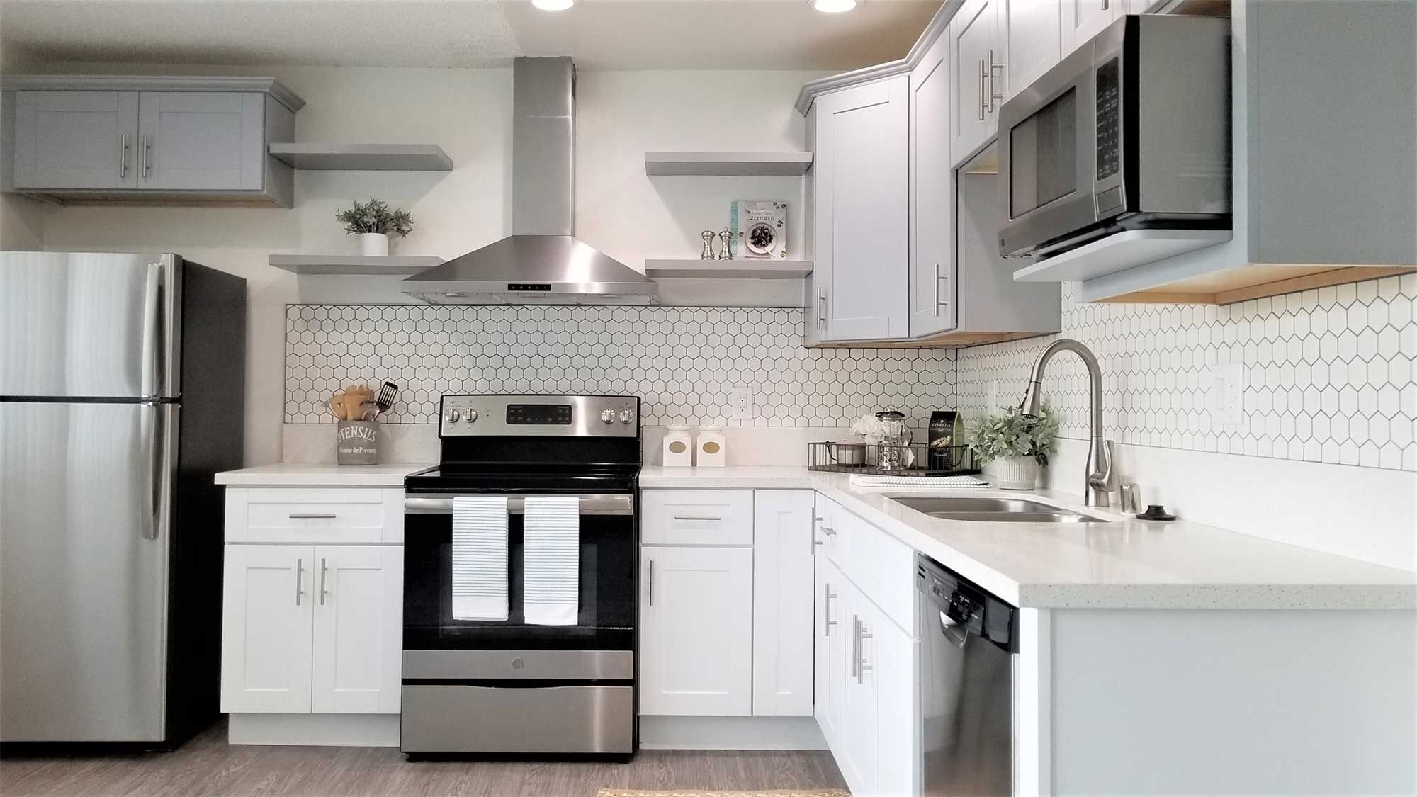 Bleu Apartments renovated kitchen with hexagon tile backsplash