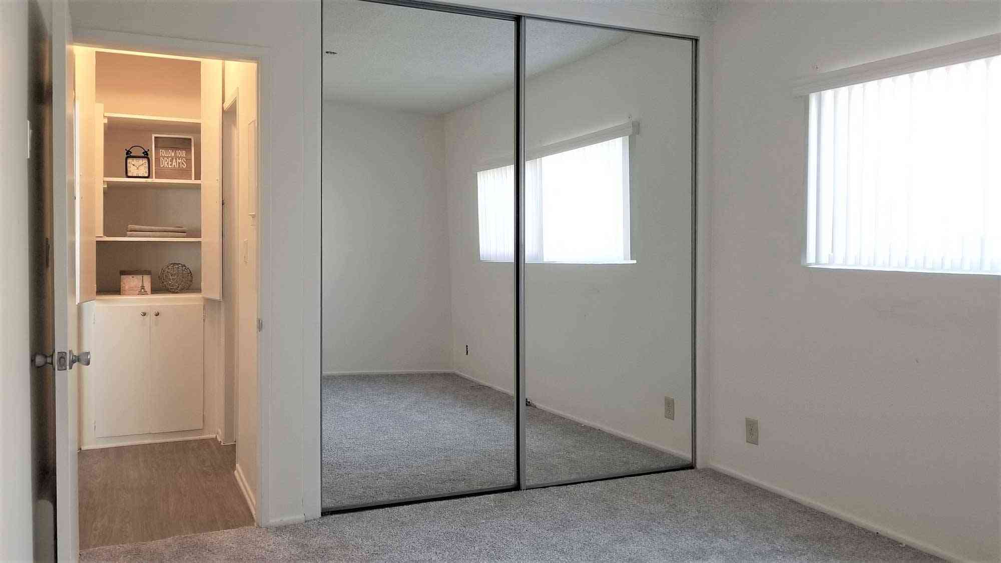 bedroom with mirrored closet doors