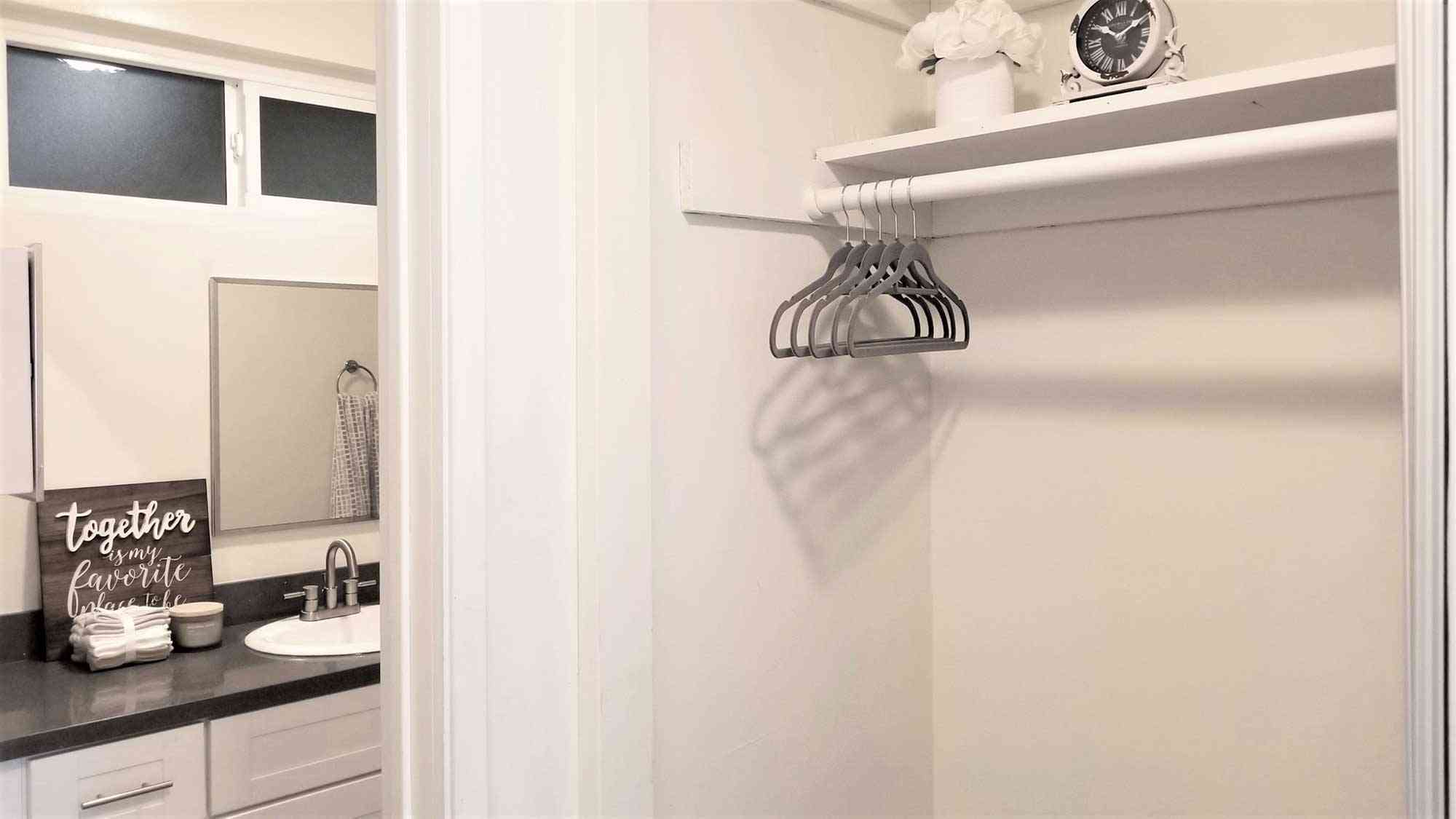 closet storage and bathroom vanity view