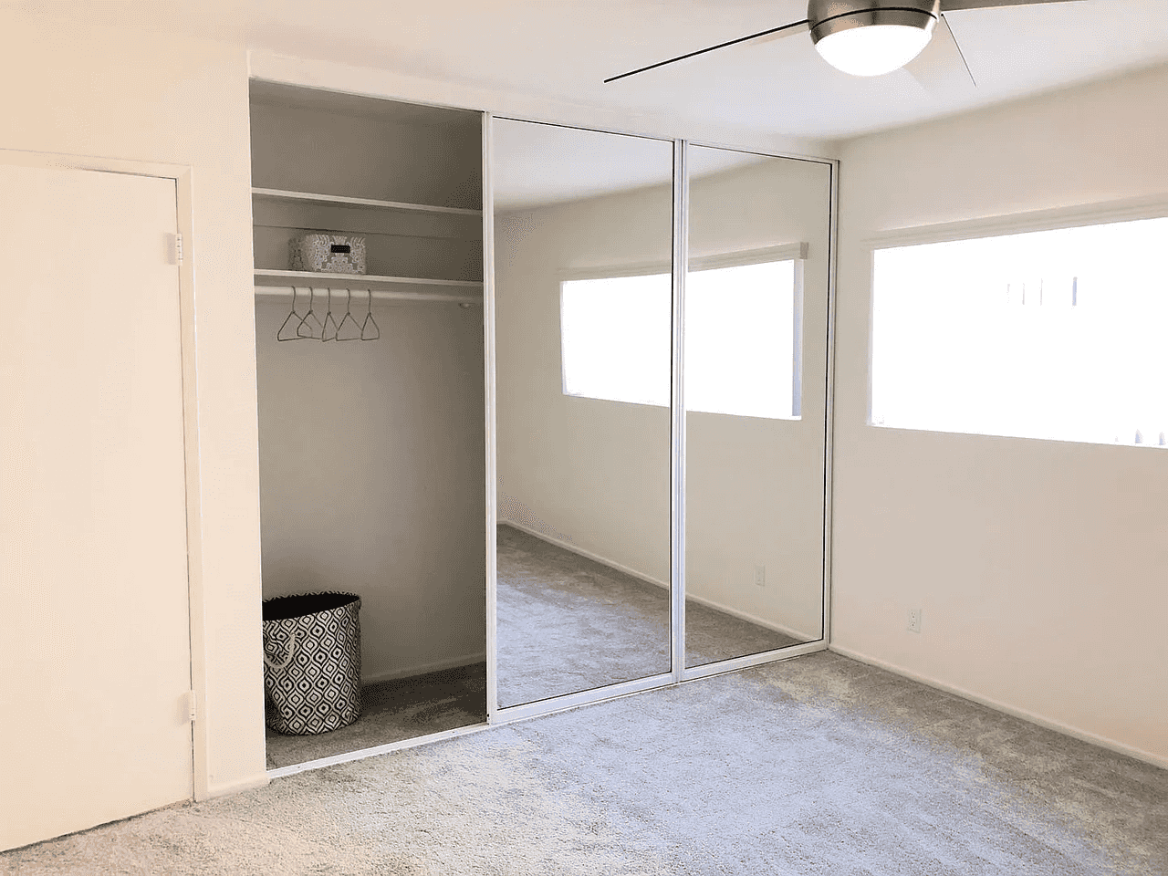 modern bedroom with ceiling fan and storage