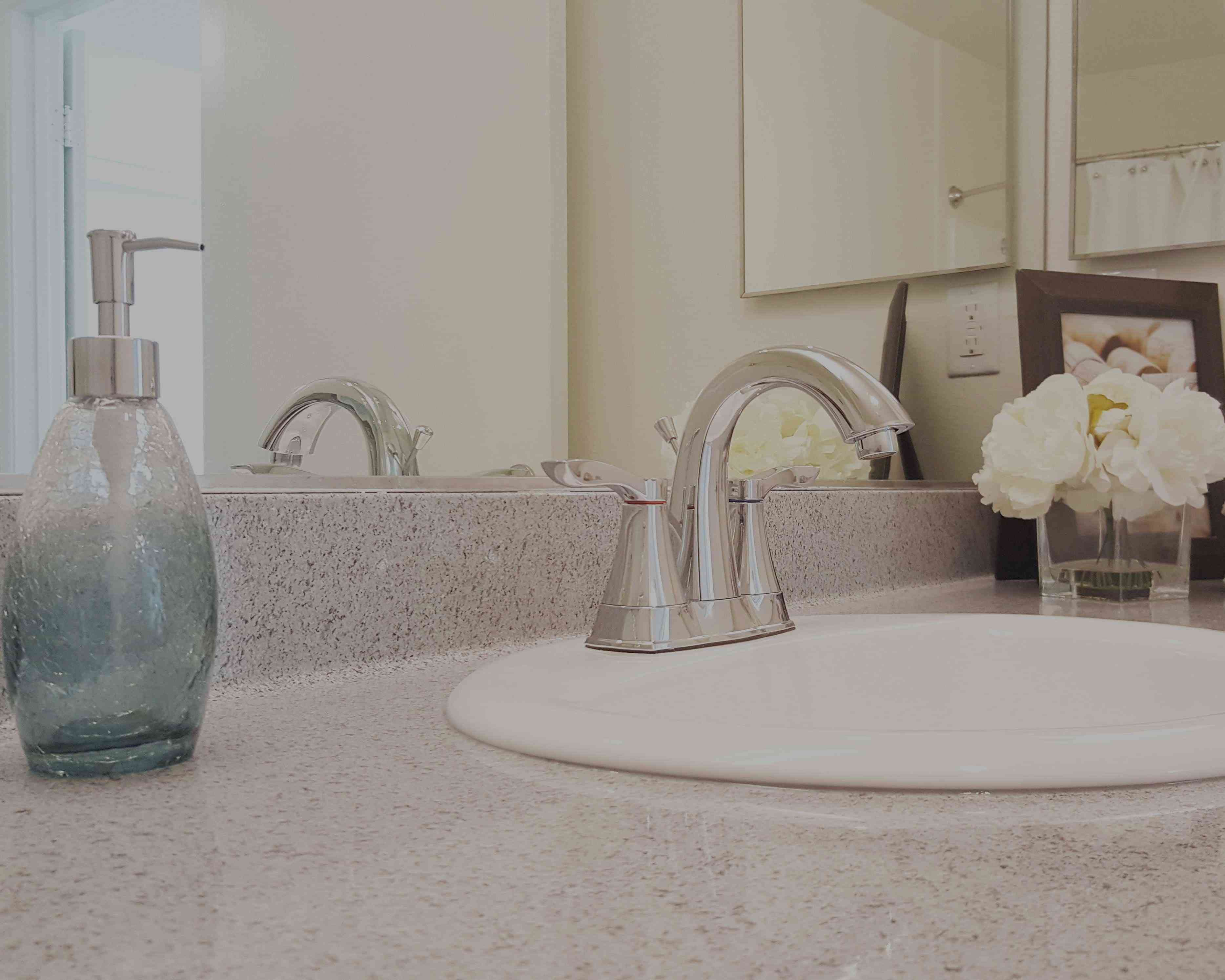 bathroom faucet and quartz countertop detail